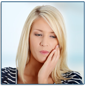 Woman grabbing her jaw in need of an emergency dentist