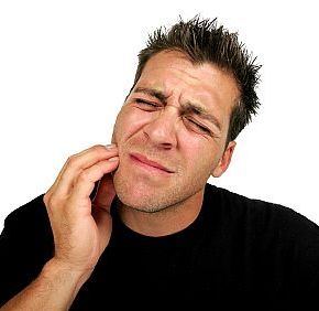Man holding his cheek in need of an emergency dentist