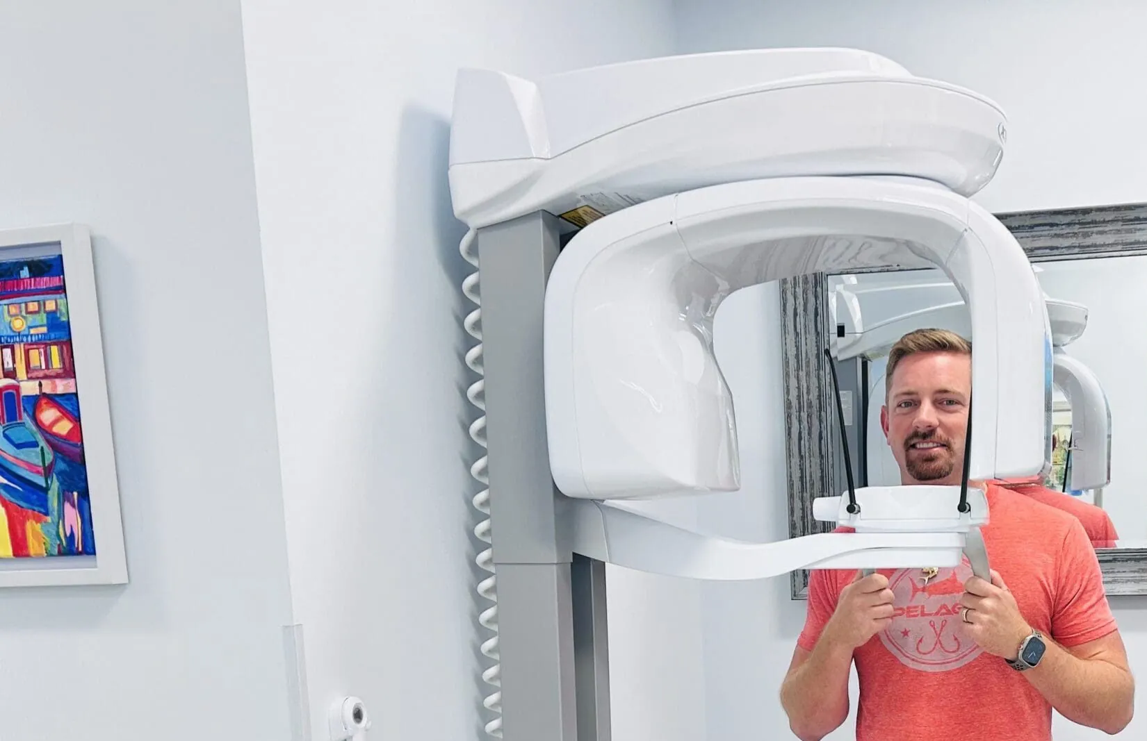 A dental patient getting ready for his dental scan using a large machine